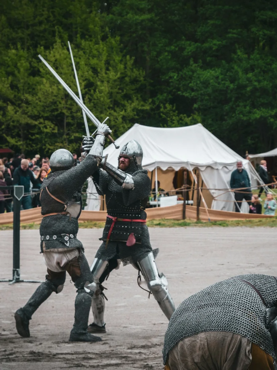 Two performers with swords, mid-fight